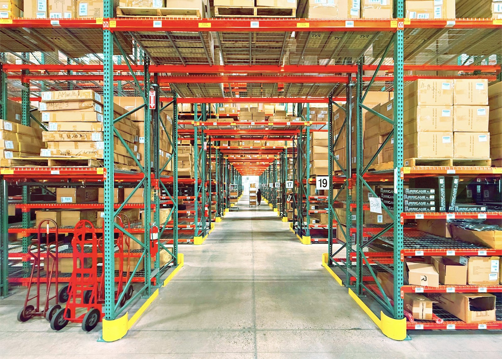 Warehouse racking in long perspective — the stock ROOSTER ERP keeps honest